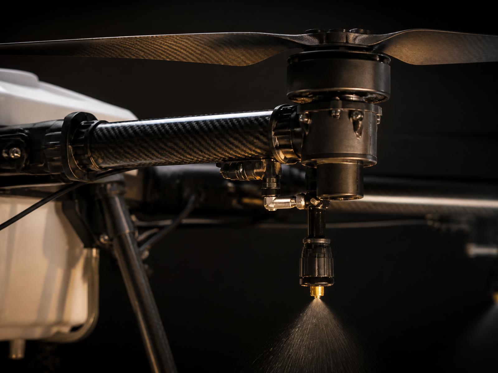 Close-up of a carbon fibre drone arm with a precision spray nozzle